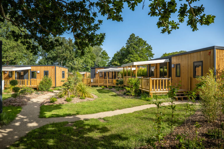 Village de mobile homes au camping de Mesqueau entouré de verdure